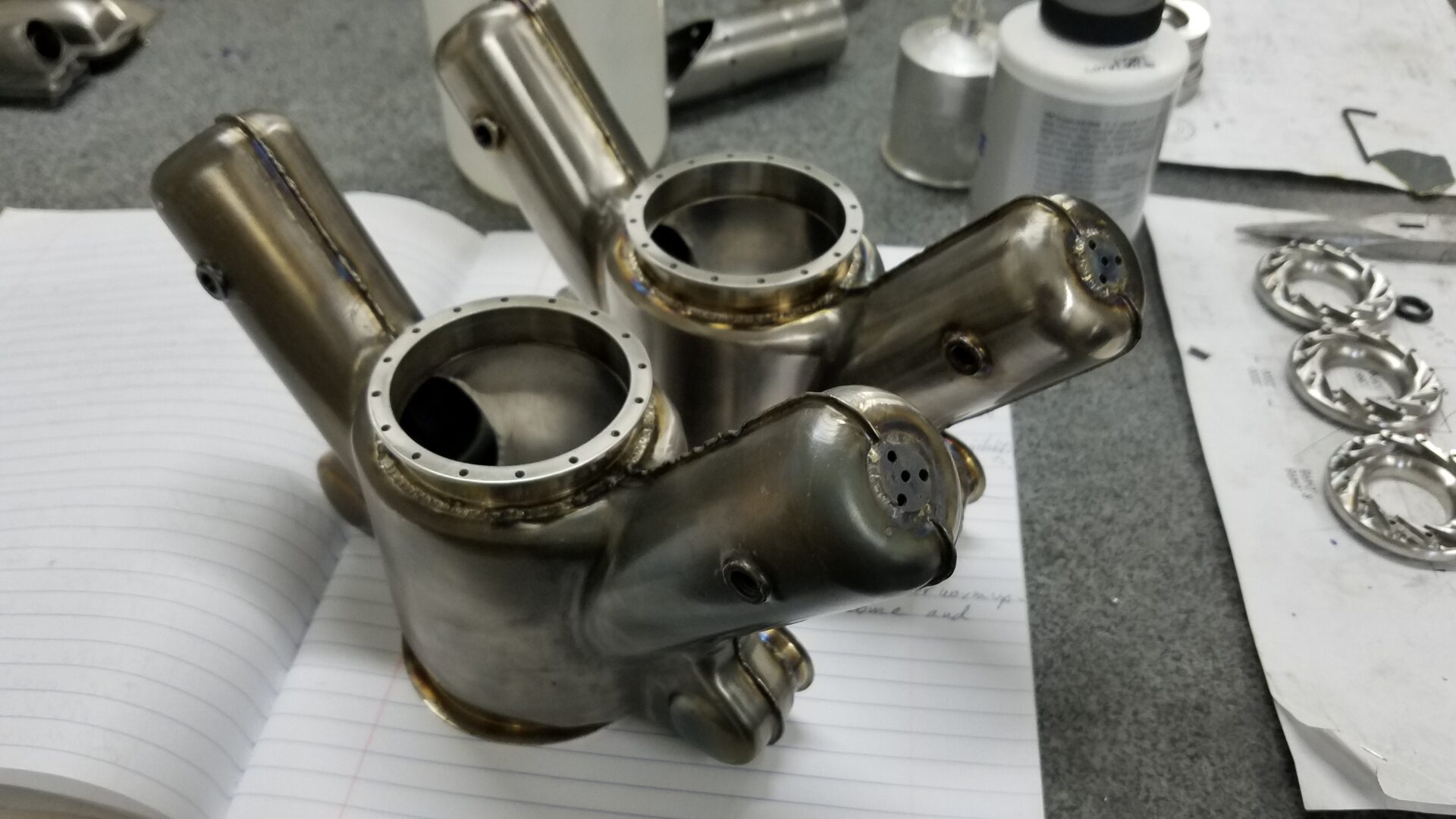 A group of metal parts sitting on top of paper.