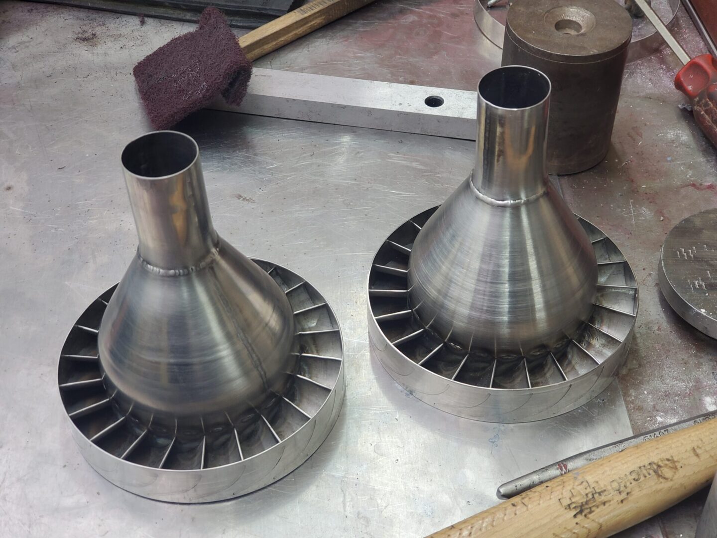 Two metal cones sitting on top of a table.