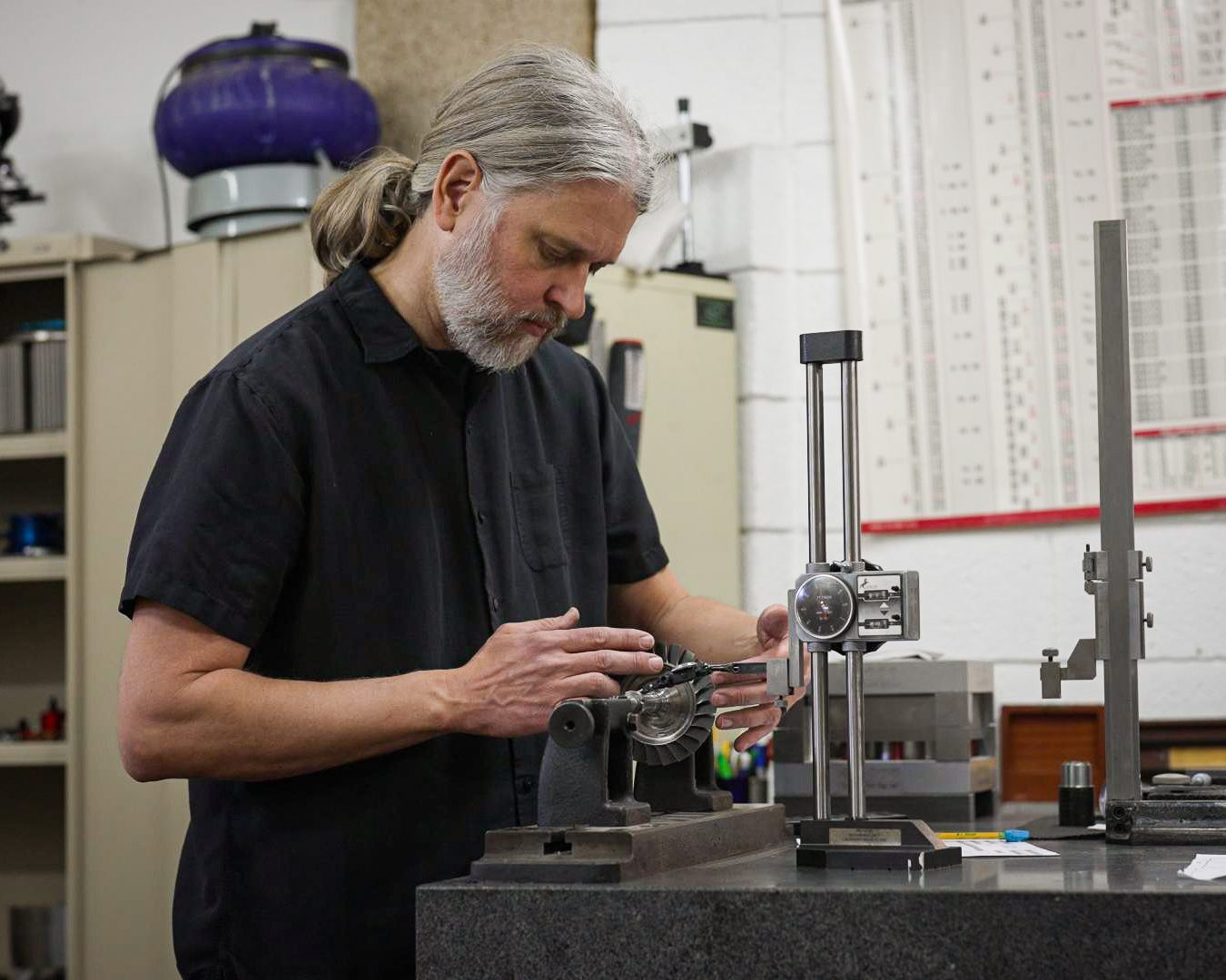A man in black shirt working on machine.